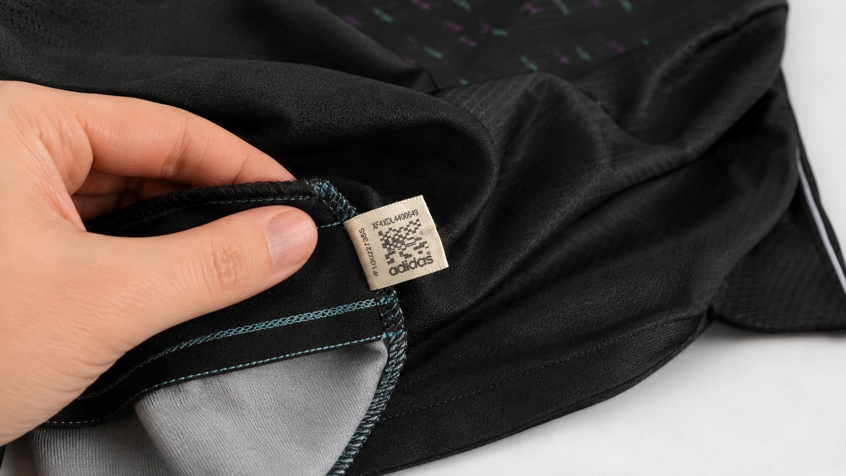 Football shirt turned inside out with side seam product label visible during review